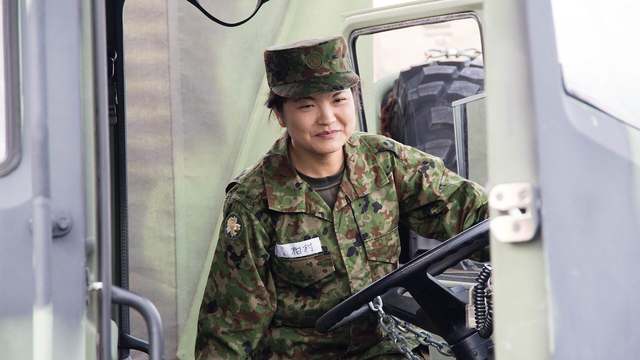 A person climbing into the driver's seat, the step those boots have to handle