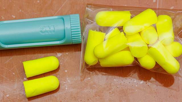 Yellow foam earplugs on a white background