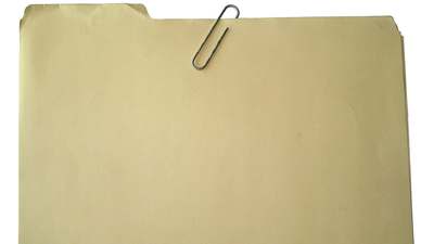A manila folder with a paperclip, for the papers that stay in the truck