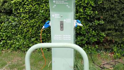 A power pedestal with blue shore-power sockets at a motorhome stopover