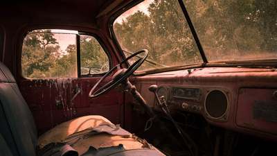 The interior of a truck cab, with the driver's seat and dash